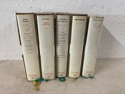 four books are stacked on top of each other on a table