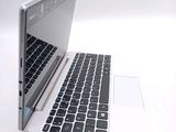 a white laptop with a black keyboard on a white surface