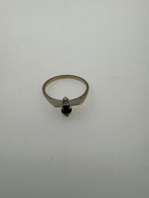 a silver ring with a black stone on top of it