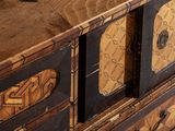 a close up of a chest of drawers with a clock on top of it