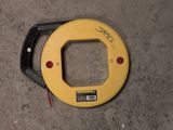 a close up of a yellow circular device on a concrete floor