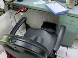 a black chair in a barber shop with a mirror