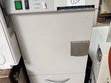 a white dishwasher sitting next to a dryer in a room