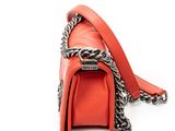 a close up of a red purse with a chain around it