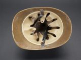 a brown bowl that has a black and white design on it