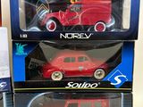 three red toy cars sitting on top of each other