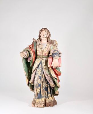 an old statue of a woman holding a book in her hands