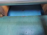 a blue floor with a metal rail and a blue wall