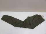 olive green pants on a white table with a tag on it