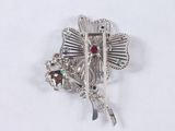 a silver brooch with a red and blue stone in it