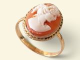 an image of a gold ring with a carved cameo of a woman