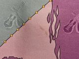 a close up of a tie with a bird on it