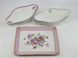 two plates with flowers on them are sitting on a table