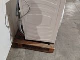 a washing machine sitting on a pallet in a room