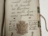 an old book with writing on it sitting on a table