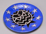 a blue plate with a black and white design on it