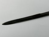 a black pen sitting on top of a white table