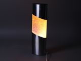 a close up of a lamp on a table with a black background
