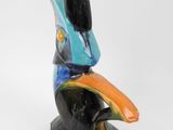 a ceramic bird that is sitting on top of a table