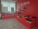a red wall that has a bunch of shoes on it