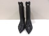 black leather booties with a woven design on the heel