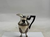 an antique silver plated coffee pot on a piece of paper
