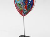 a heart shaped sculpture with two birds on top of it