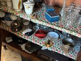a wooden cabinet with a bunch of dishes and cups on it