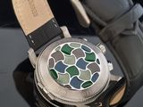 a close up of a watch on a black surface