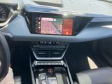 the interior of a car with a touch screen and steering controls