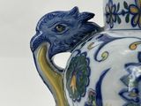 a blue and white vase with a bird on it