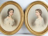 two framed portraits of a woman and a man in formal dress