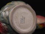 a close up of a vase on a table