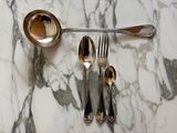 marble table with silverware and spoons on top of it