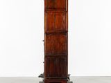 an image of a tall wooden cabinet sitting on top of a metal cart
