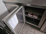 a small refrigerator that is open on the floor
