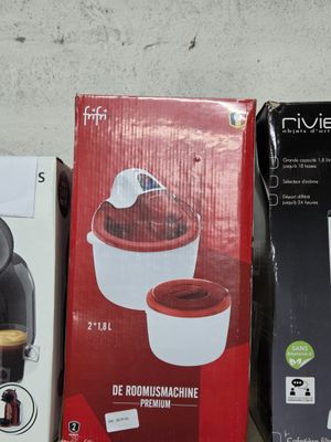 three boxes of coffee machines sitting on a table