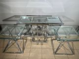 a glass table with four chairs and a glass top