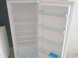 a white refrigerator with its door open on the floor