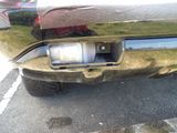 a close up of a car ' s rear end with a reflection on it