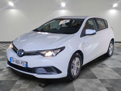 the white toyota corollant is parked in a large room
