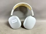 an image of a pair of white headphones sitting on top of a table