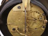 a close up of a clock that is on a table