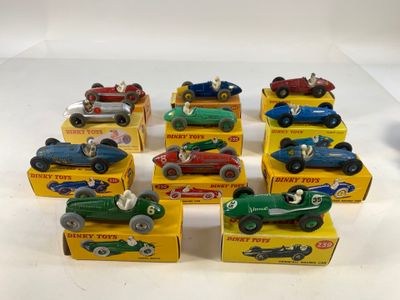 six toy cars are lined up in a row on a white surface
