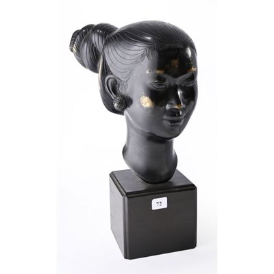 sculpture of a woman ' s head with a bun on a black base