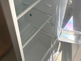 a white refrigerator with its door open and a freezer door open