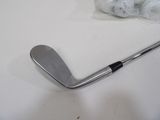 a close up of a golf club and a golf ball on a table
