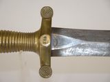 a close up of a knife on a white surface