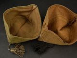 pair of brown hats with tassels on a black surface