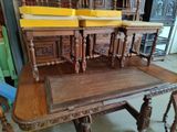 three wooden chairs sitting on top of a wooden table